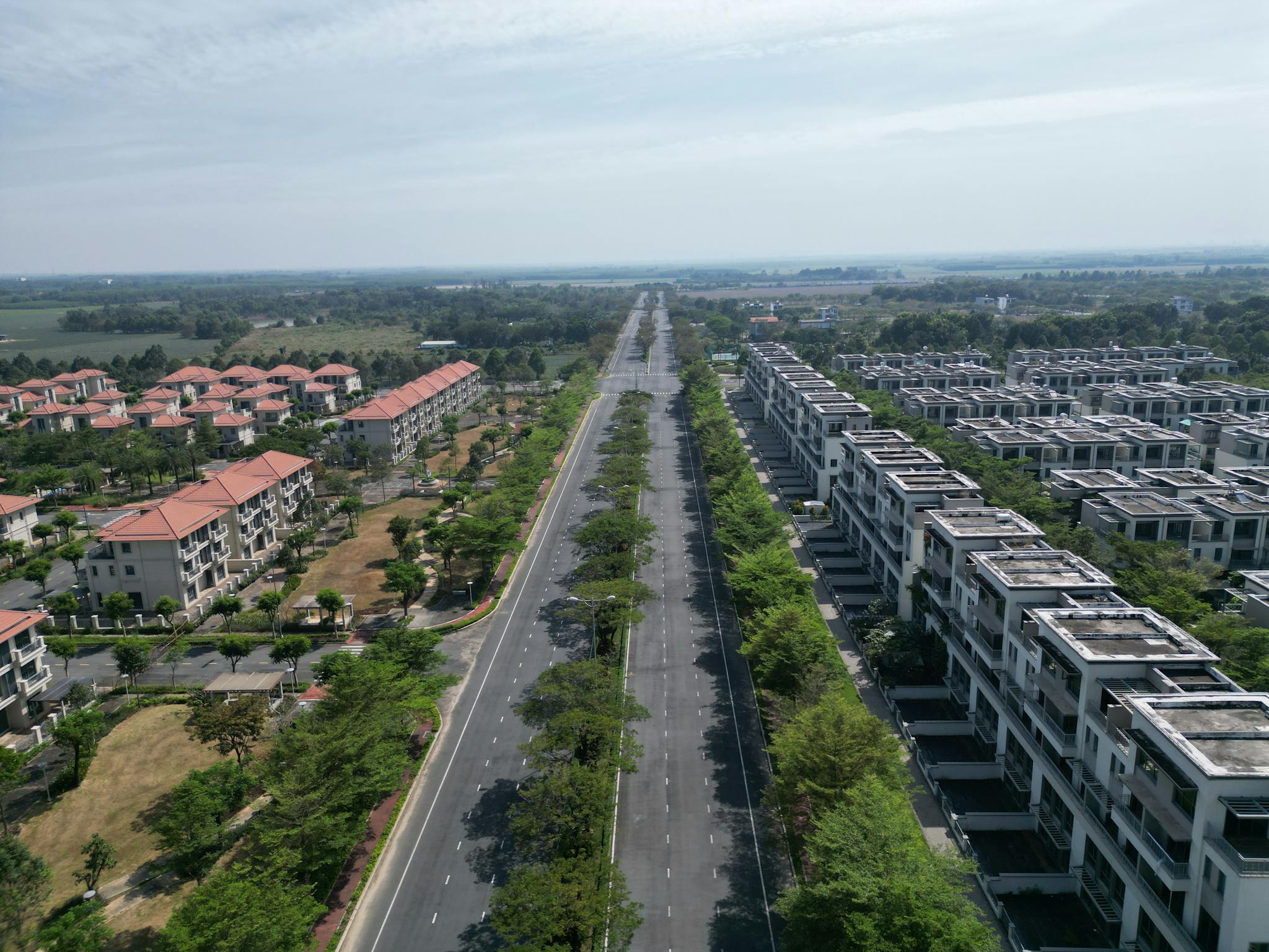 Aerial photograph of a sprawling residential area in Dong Nai, Vietnam showcasing modern architecture and wide roads.