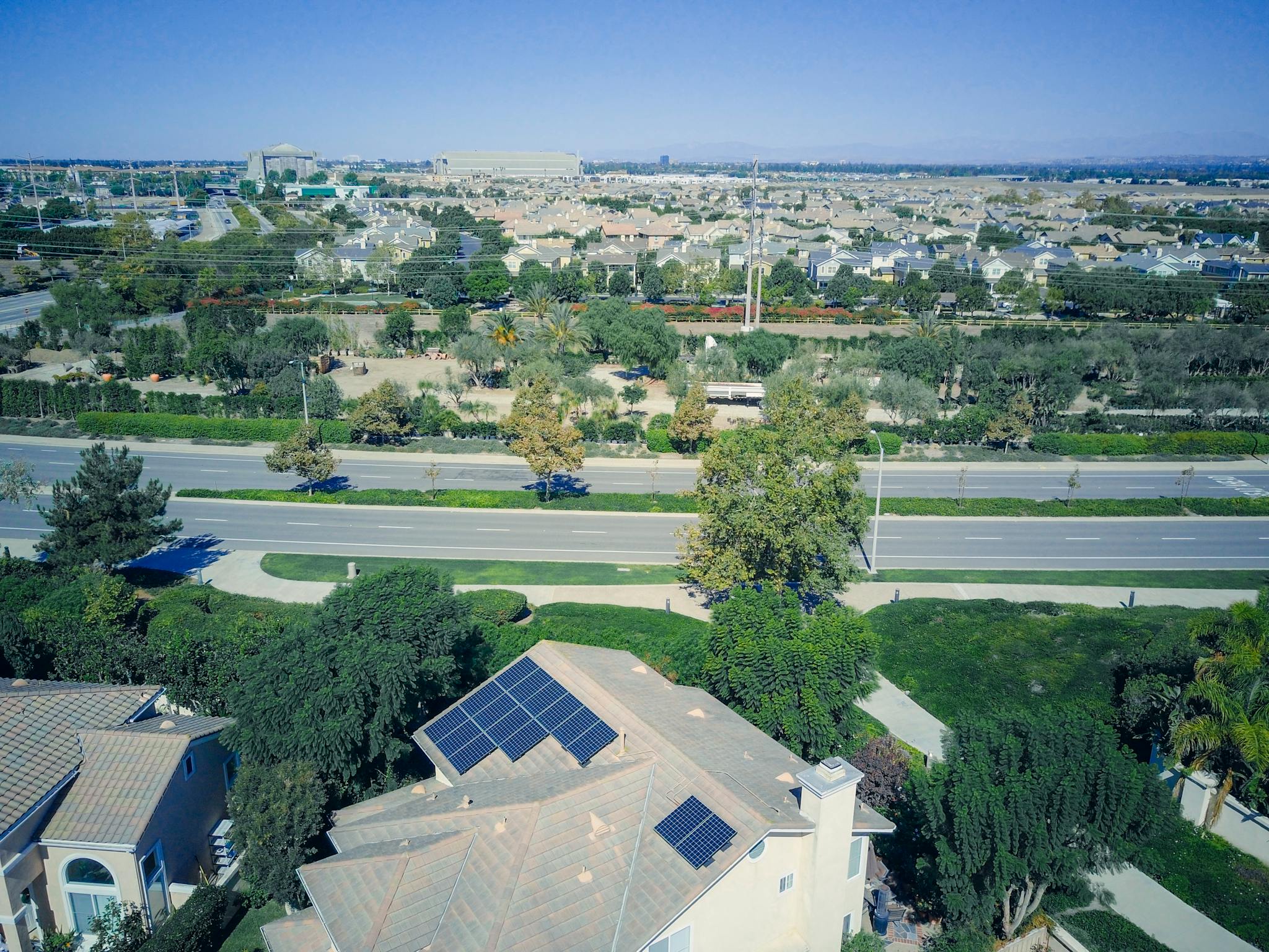Aerial view showing suburban houses with solar panels, showcasing clean energy.